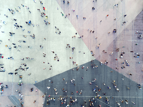 Overhead shot of people walking in a busy intersection 