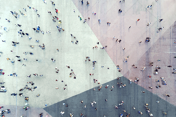 Overhead shot of people walking in a busy intersection 